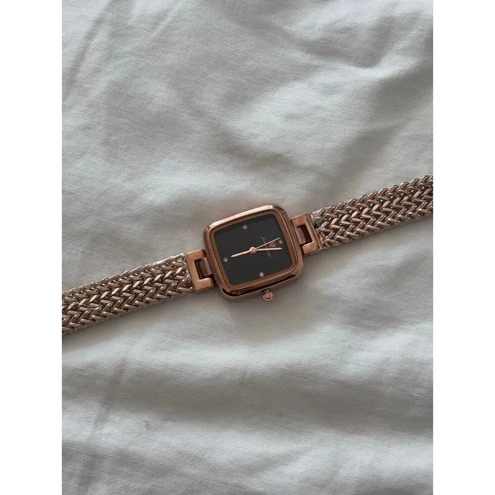 Rose gold watch with black accents